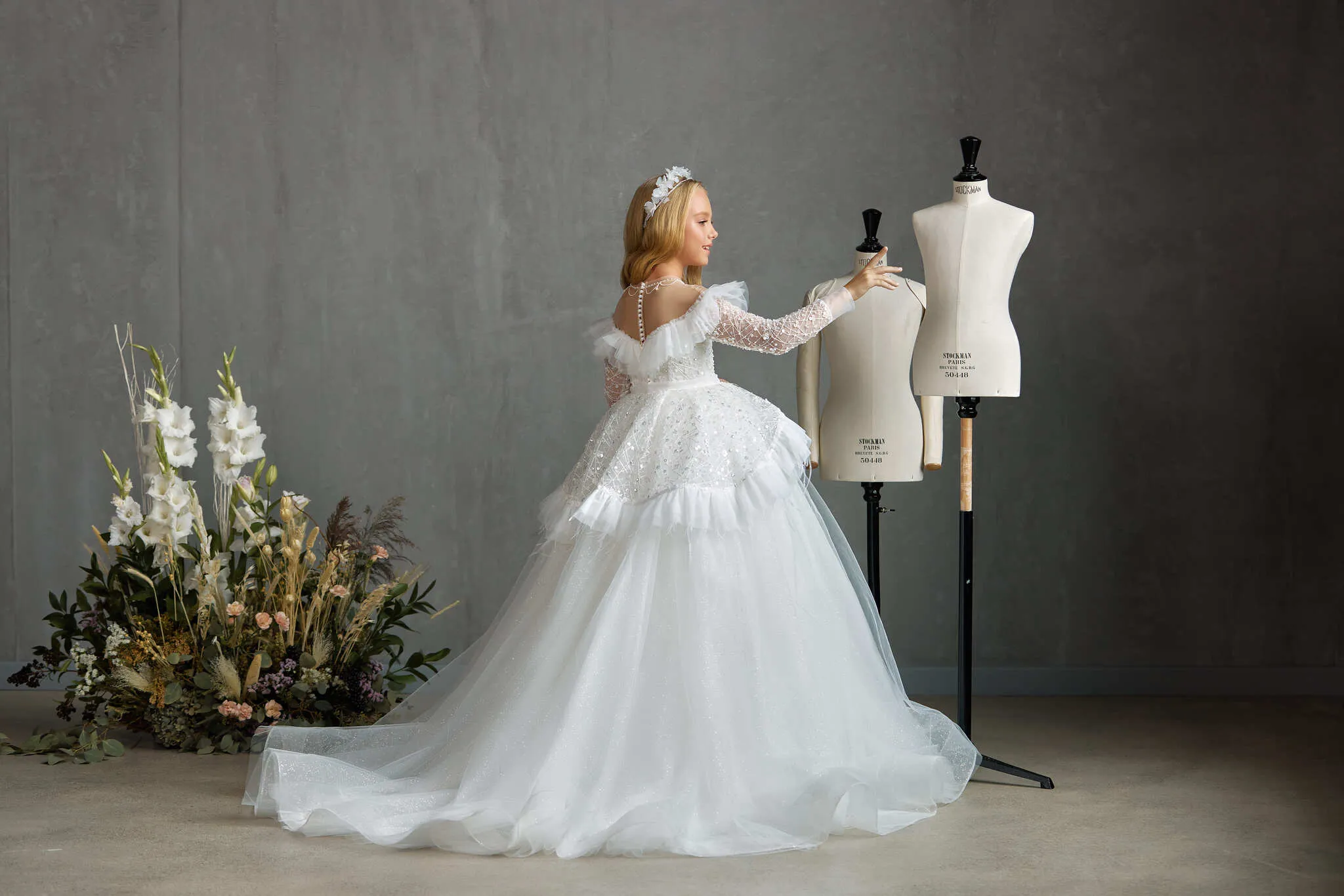 BOSTON – STRIKING OFF-THE-SHOULDER COMMUNION DRESS WITH RUFFLED FEATHER PEPLUM