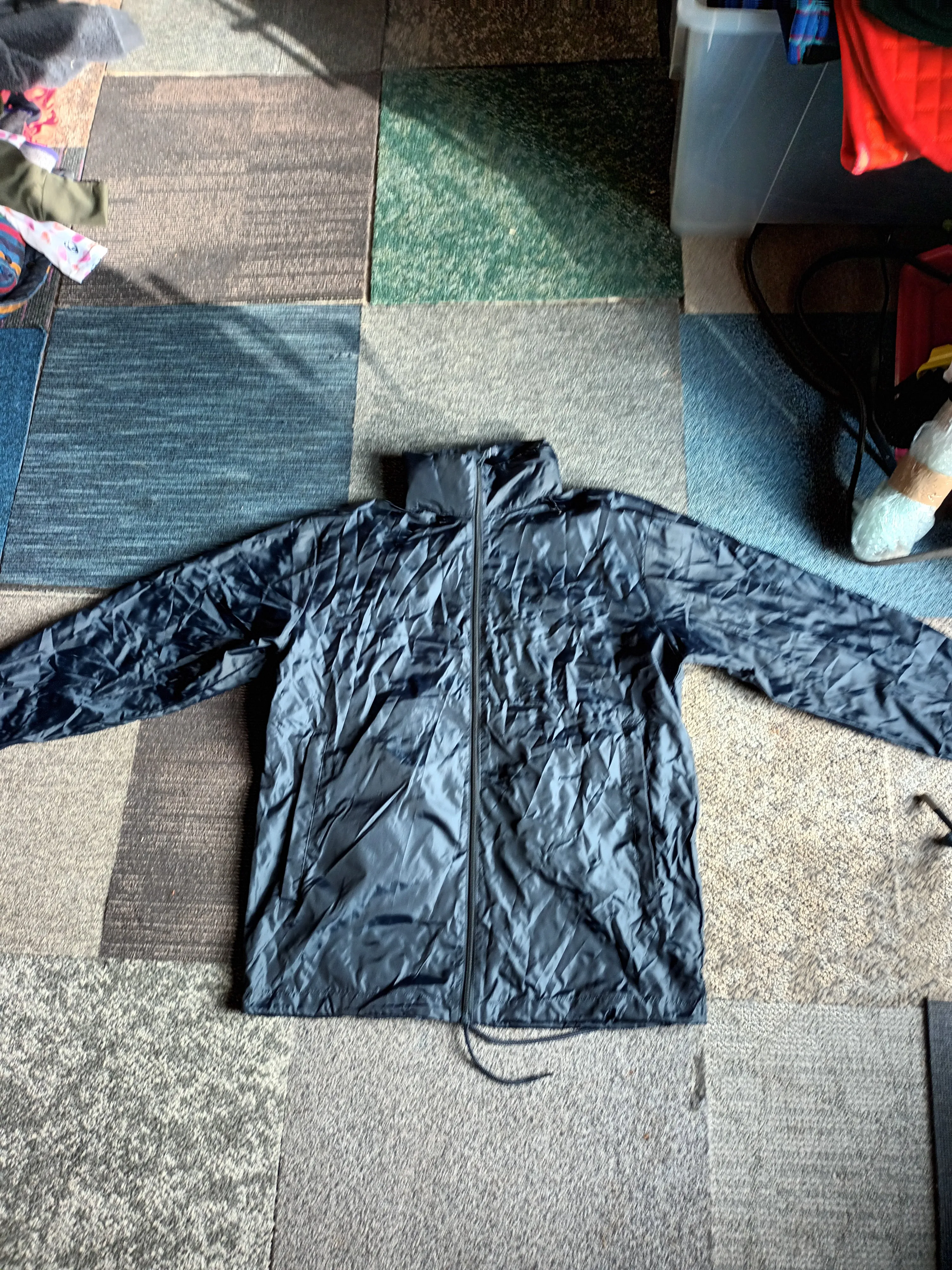 Waterproof, windproof, fold away rain jacket with hidden hood