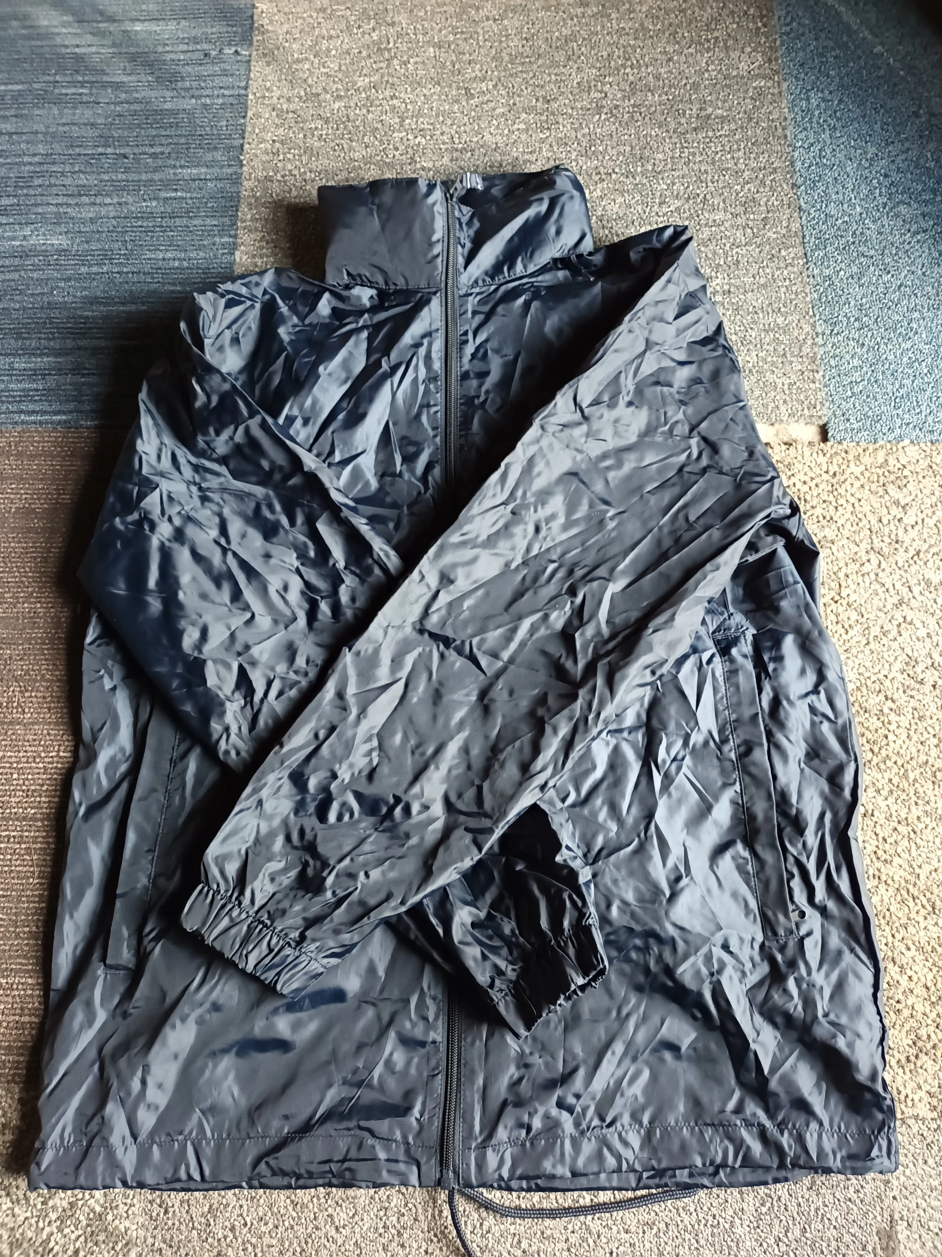 Waterproof, windproof, fold away rain jacket with hidden hood